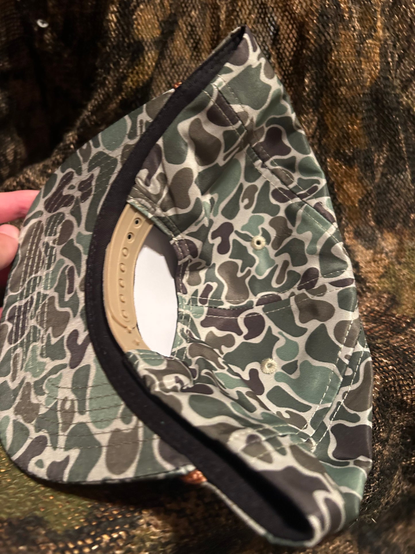 Remington patch on a jungle camo ropebrim SnapBack hat