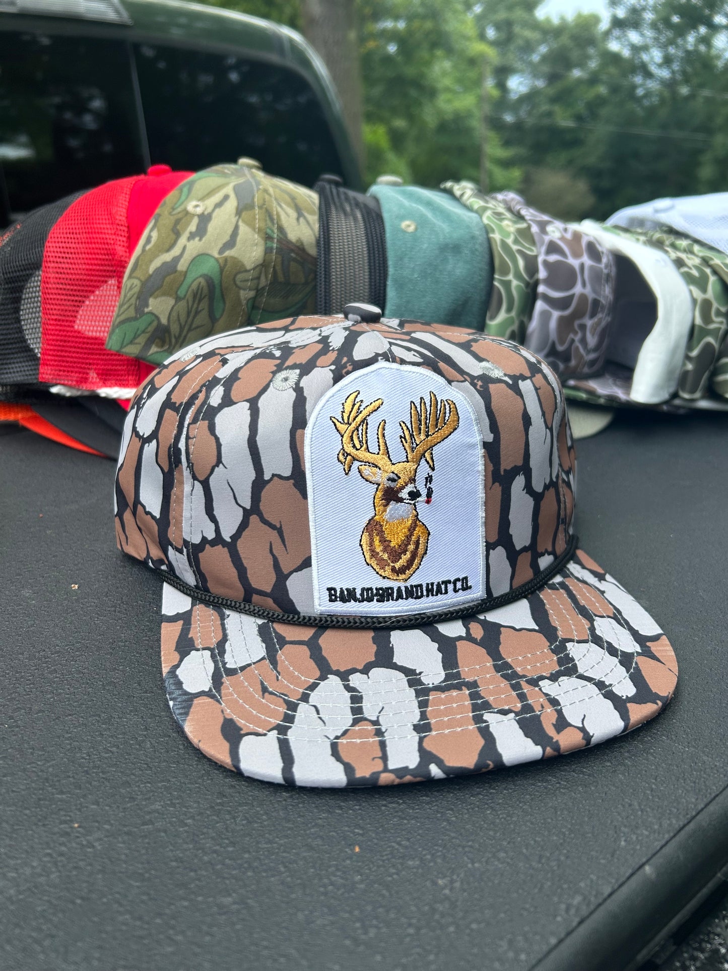 Banjo Brand smokin’whitetail patch on a oak Camo rope brim snapback hat