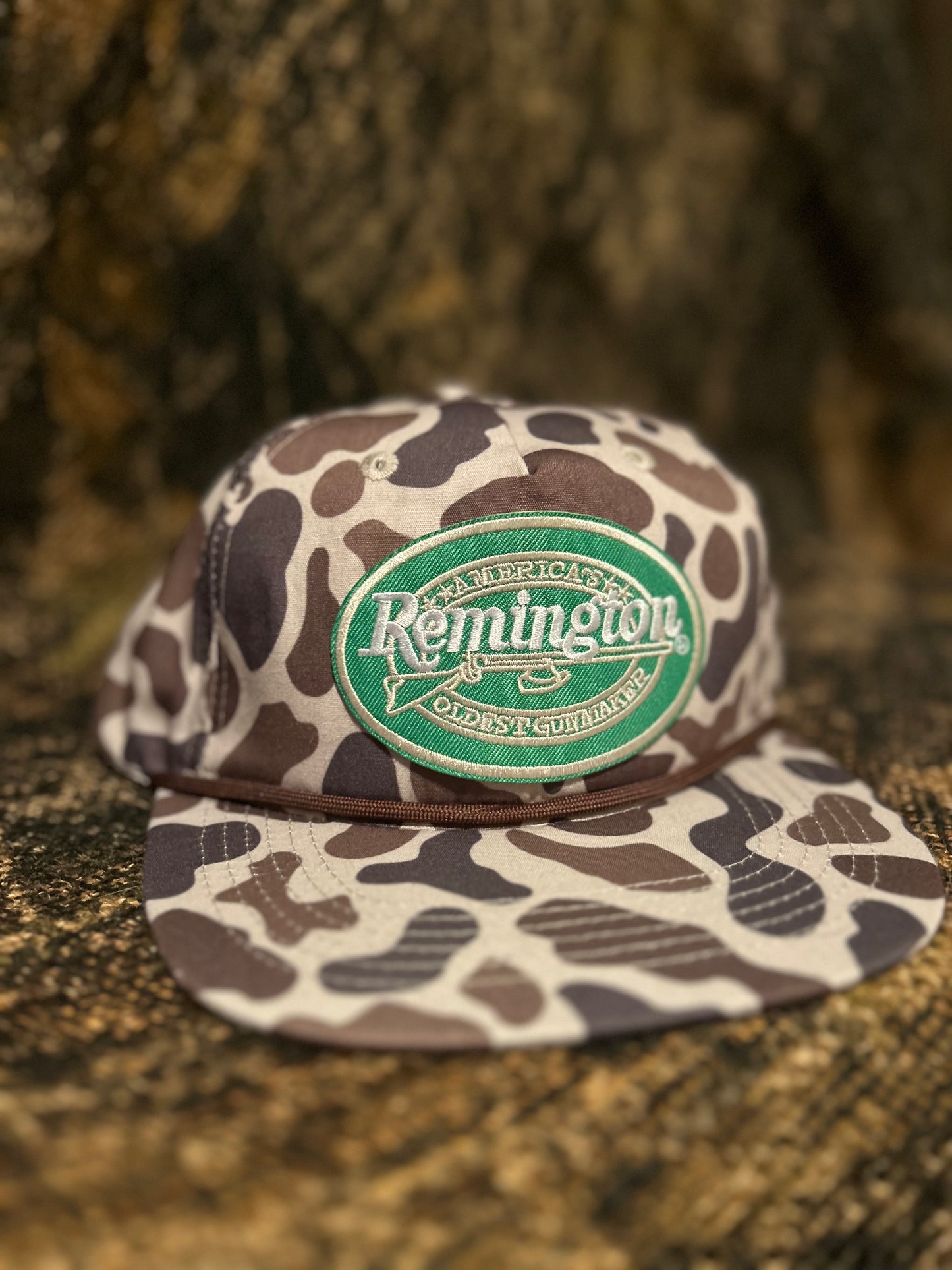 Remington patch on brown Camo ropebrim SnapBack hat