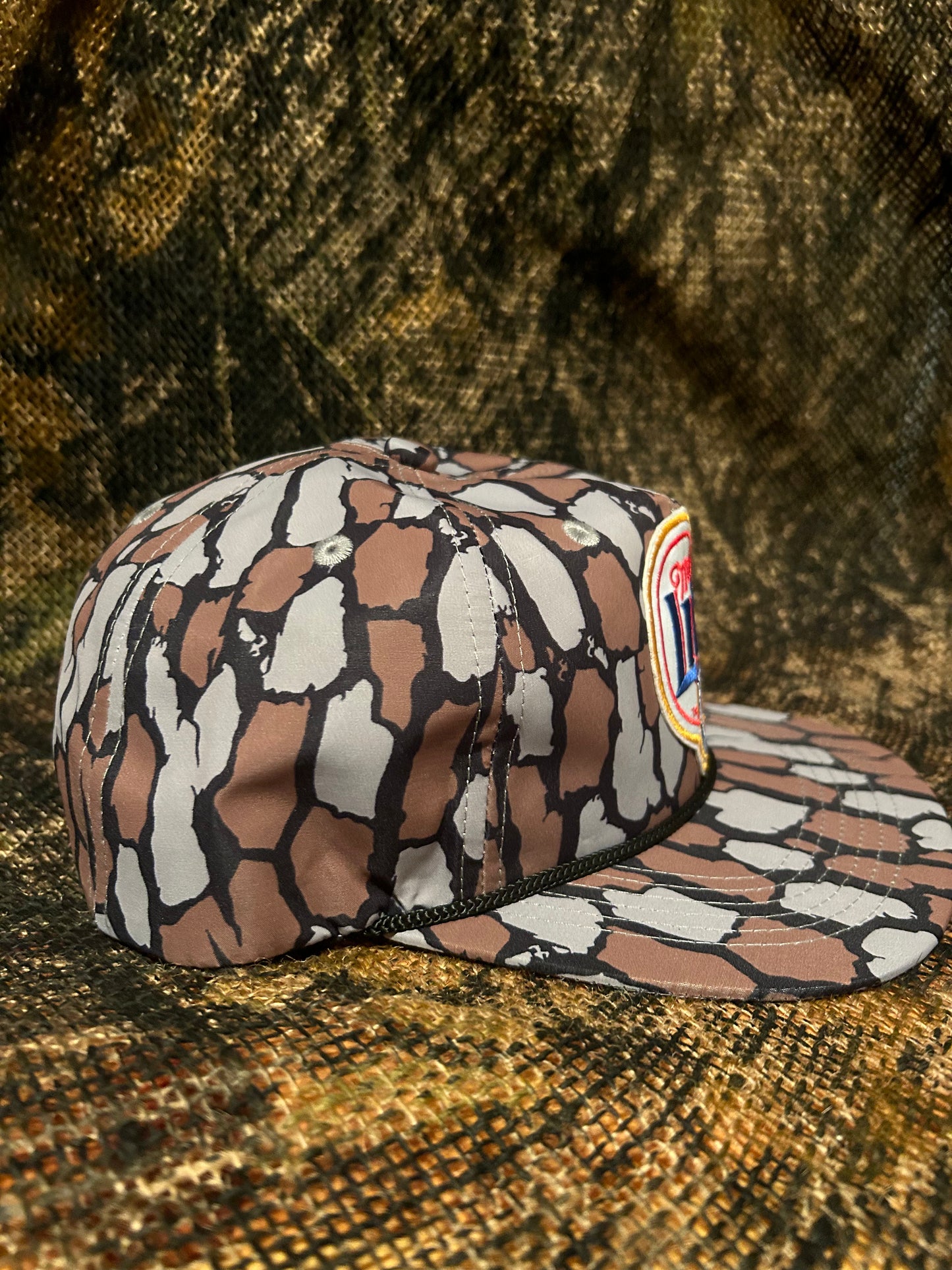 Miller lite patch on a Oak Camo ropebrim SnapBack hat