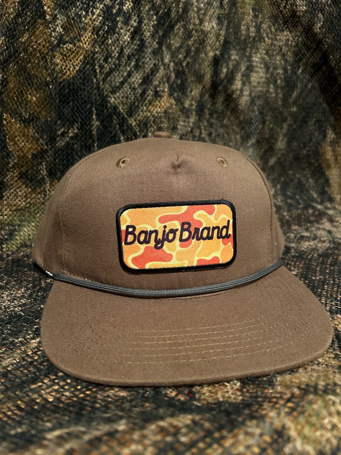 Banjo Brand script patch on a tobacco brown rope brim SnapBack hat