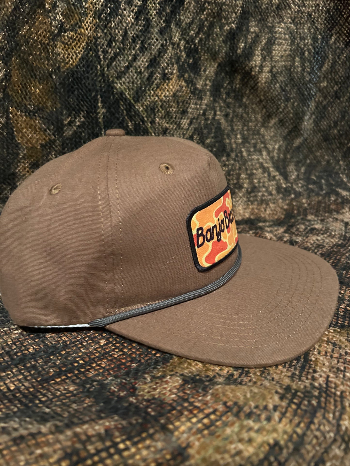 Banjo Brand script patch on a tobacco brown rope brim SnapBack hat