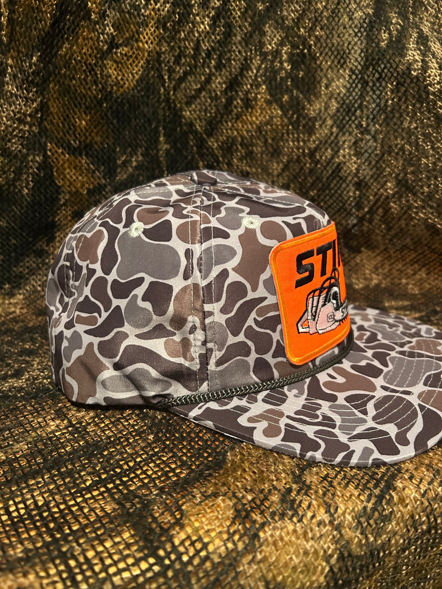 STIHL chainsaw patch on a Smokeshow ropebrim SnapBack hat