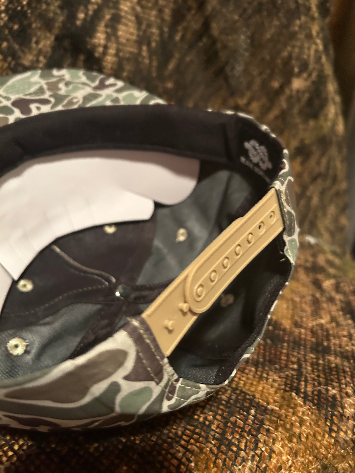 STIHL chainsaw patch on a jungle Camo ropebrim SnapBack hat