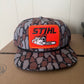 STIHL chainsaw patch on a oak camo ropebrim SnapBack hat