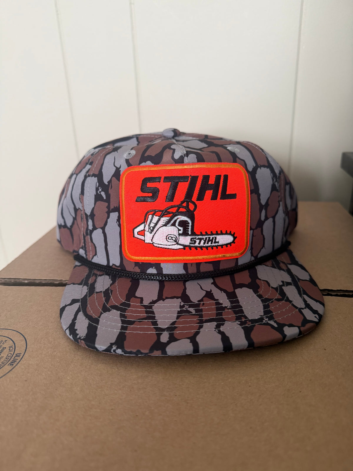 STIHL chainsaw patch on a oak camo ropebrim SnapBack hat
