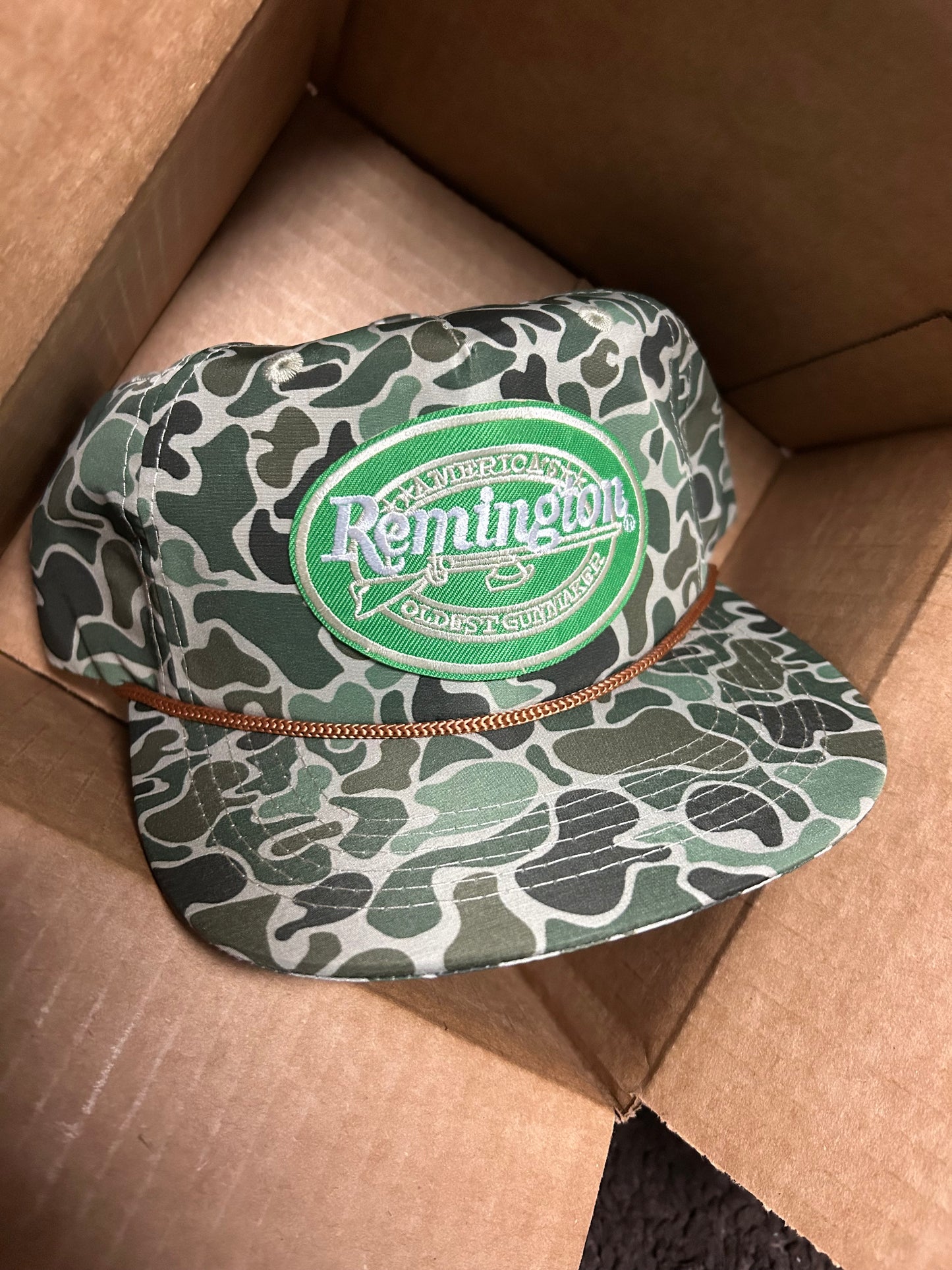 Remington patch on a jungle camo ropebrim SnapBack hat