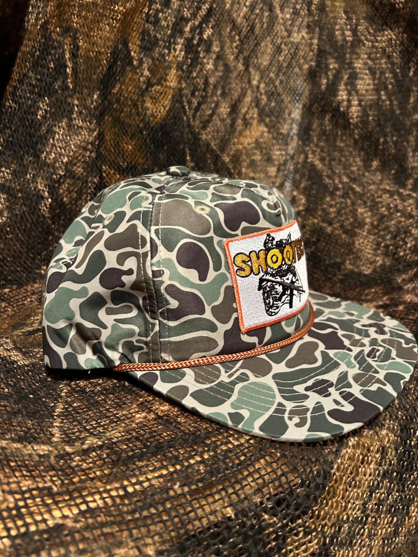 Shooters patch on a Camo SnapBack hat