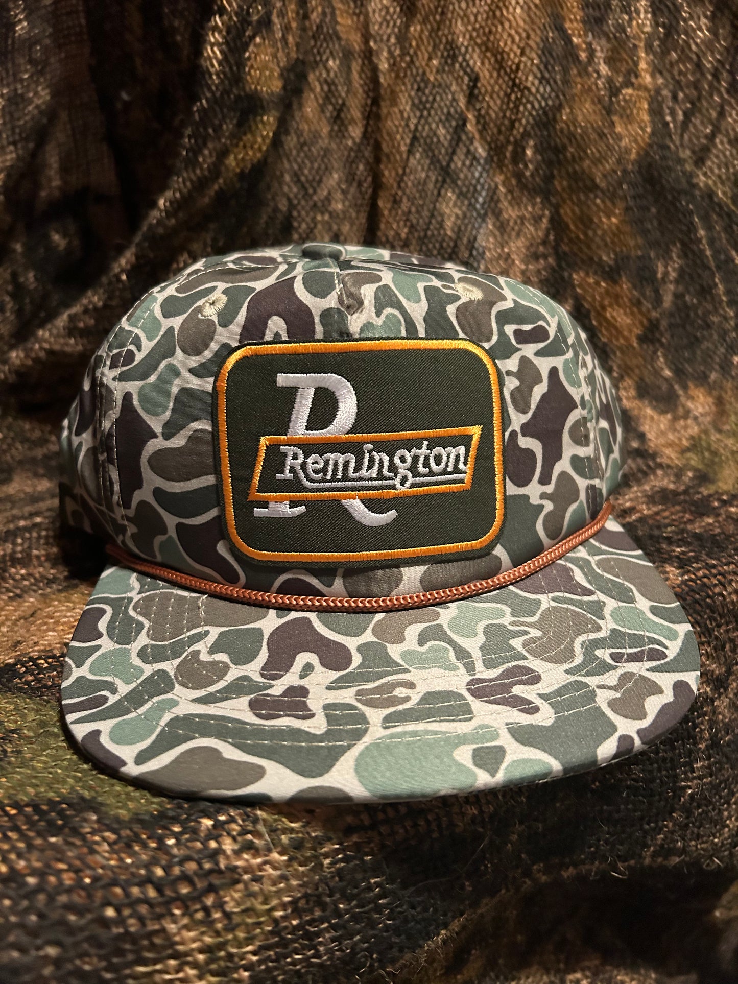 Remington patch on a Camo ropebrim SnapBack hat