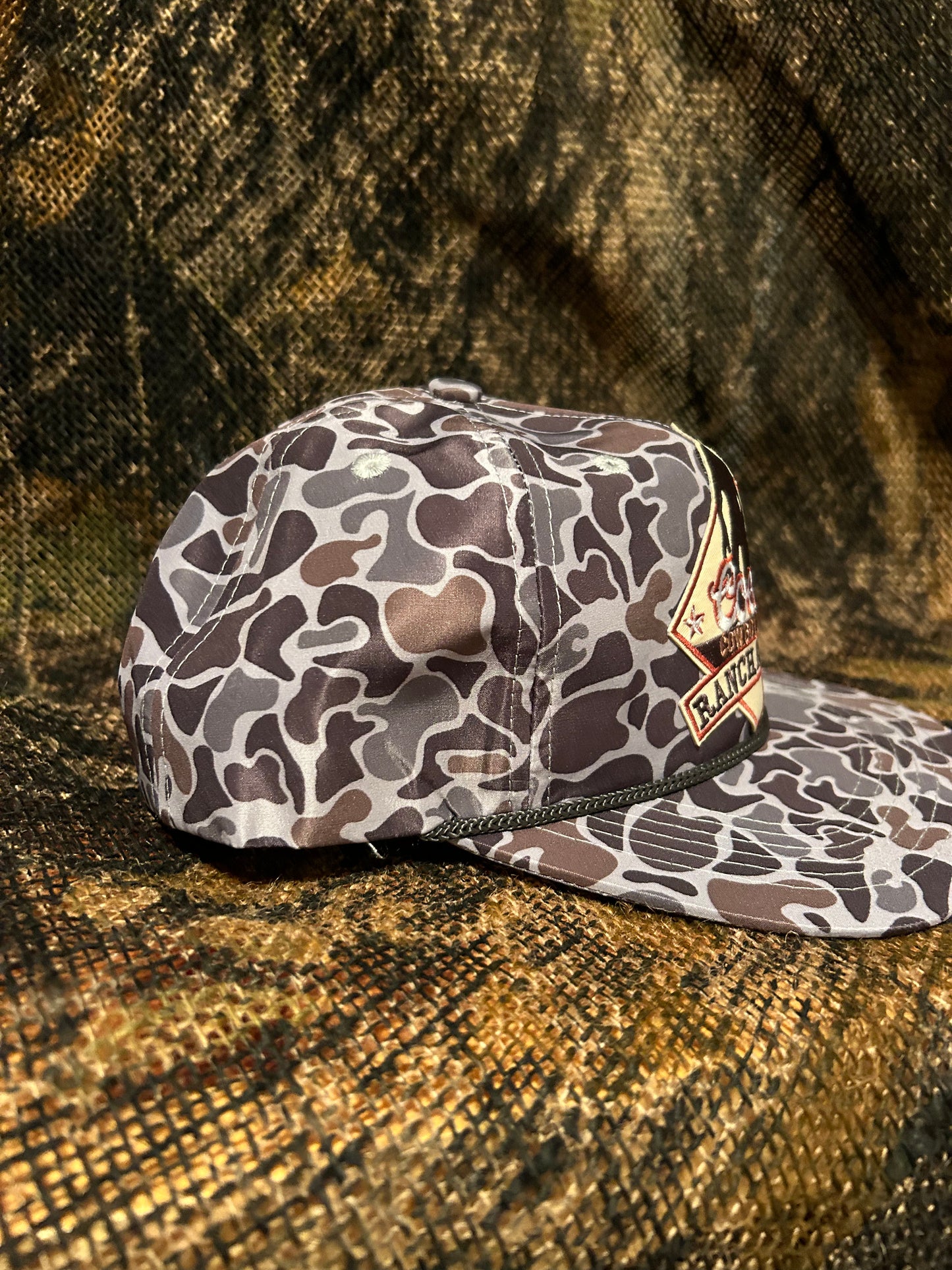 Coors Cowboy ranch rodeo patch on a Smokeshow Camo ropebrim snapback hat