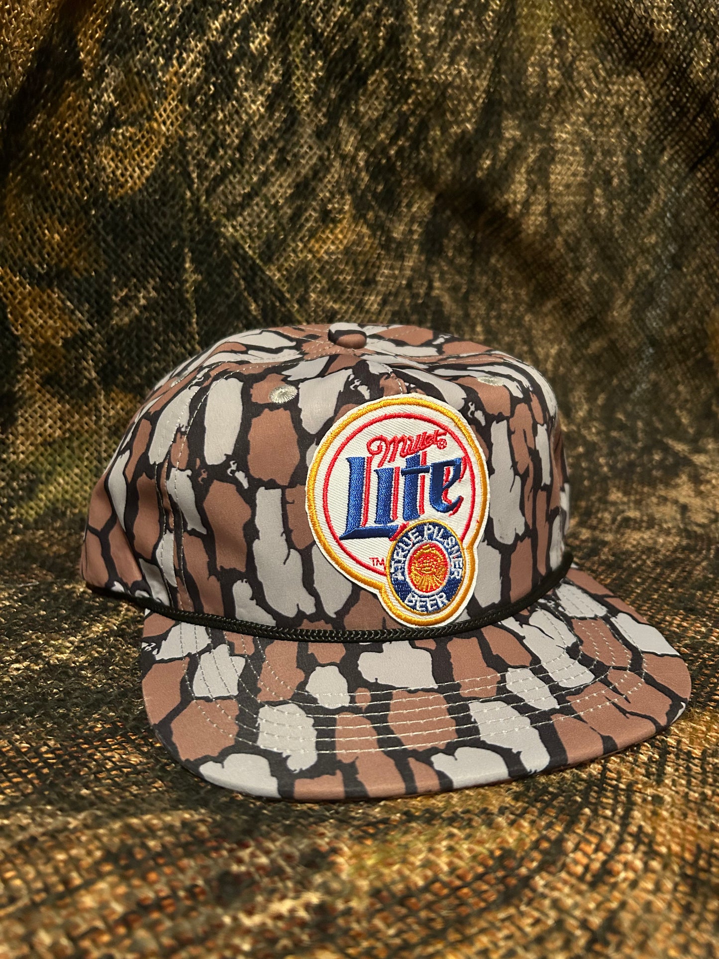 Miller lite patch on a Oak Camo ropebrim SnapBack hat