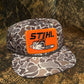 STIHL chainsaw patch on a Smokeshow ropebrim SnapBack hat