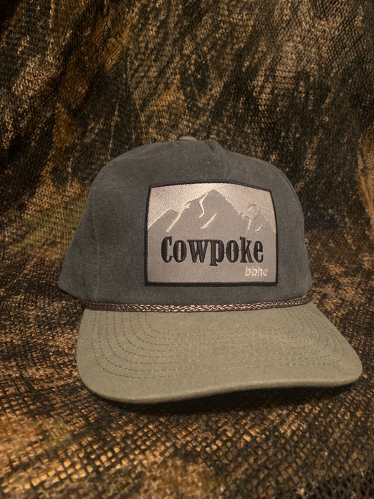 Cowpoke patch on a grey ropebrim SnapBack hat